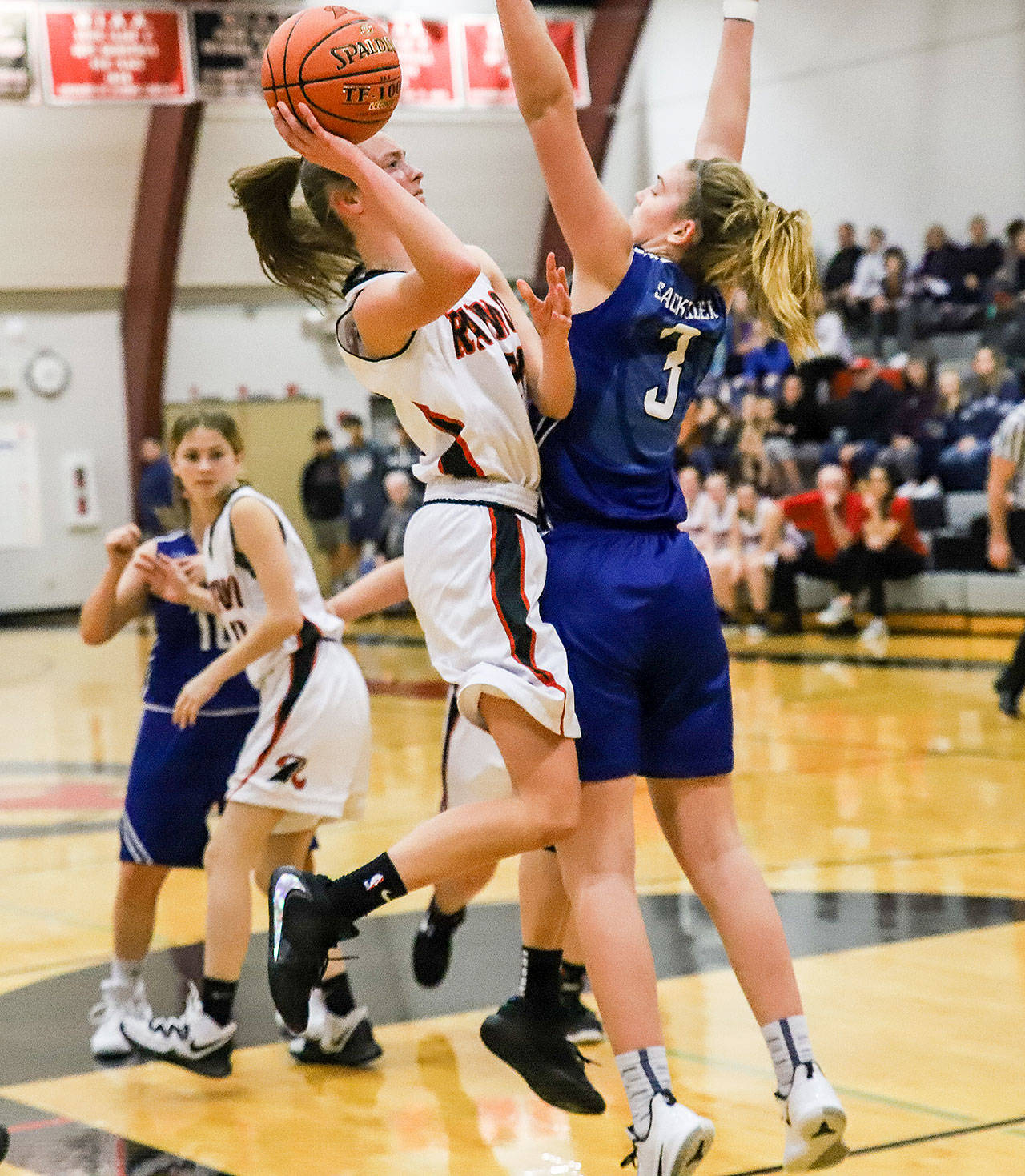 Raymond’s Kyra Gardner, left, goes up for a shot while being defended by Elma’s Jalyn Sackrider during Raymond’s 49-47 victory on Tuesday at Raymond High School. Gardner led all scorers with 30 points. (Photo by Larry Bale)