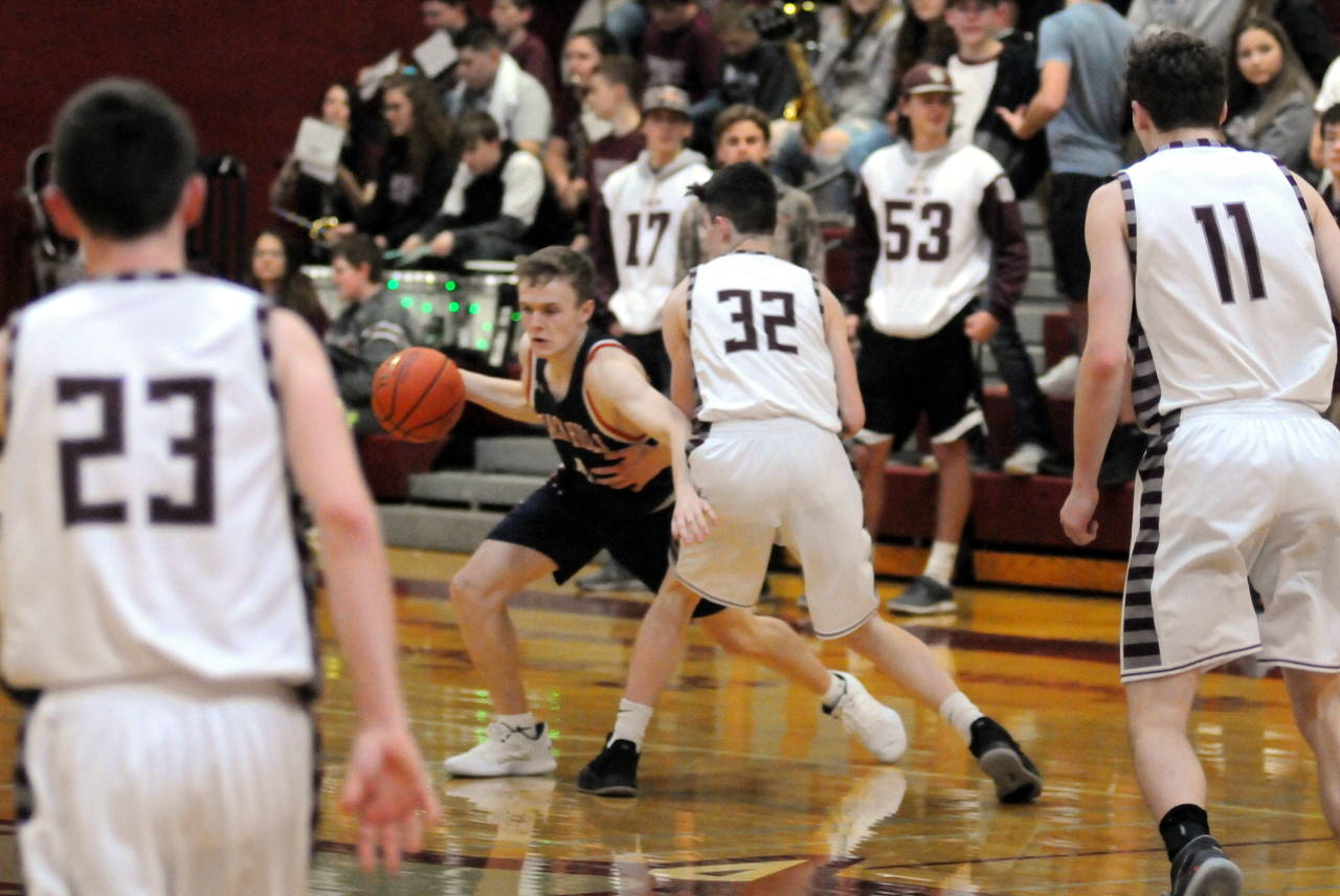 Montesano’s Caydon Lovell (32) defends Black Hills guard Jonathan Schade in Montesano’s 72-39 loss to the Wolves on Tuesday in Montesano. (Ryan Sparks | Grays Harbor News Group)