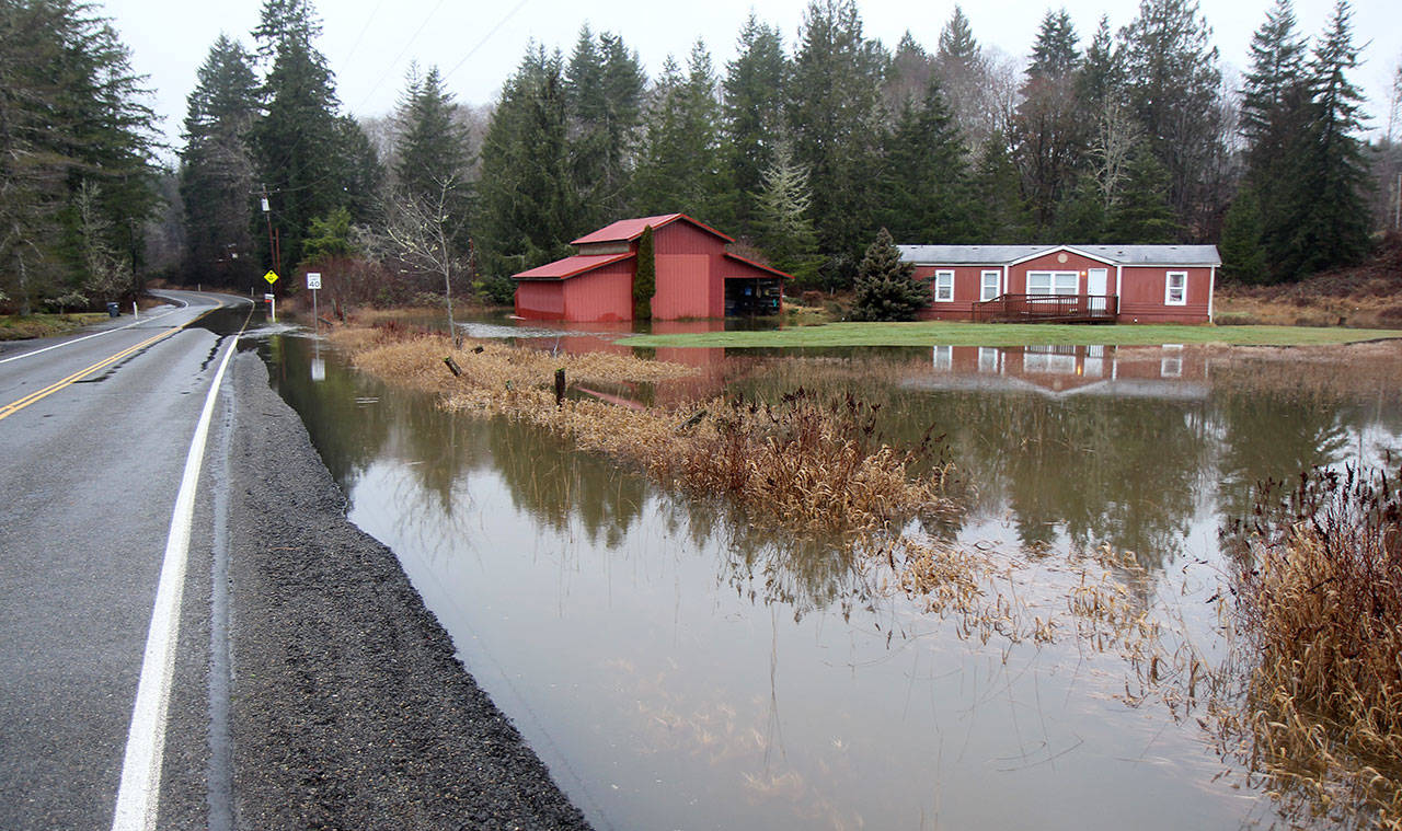 Flood water flows Tuesday (Jan. 7, 2020) through a yard then over the Mox-Chehalis Road near Porter, Washington. Grays Harbor Emergency Management closed multiple roads because of water or landslides Tuesday. (Michael Lang | Grays Harbor News Group)