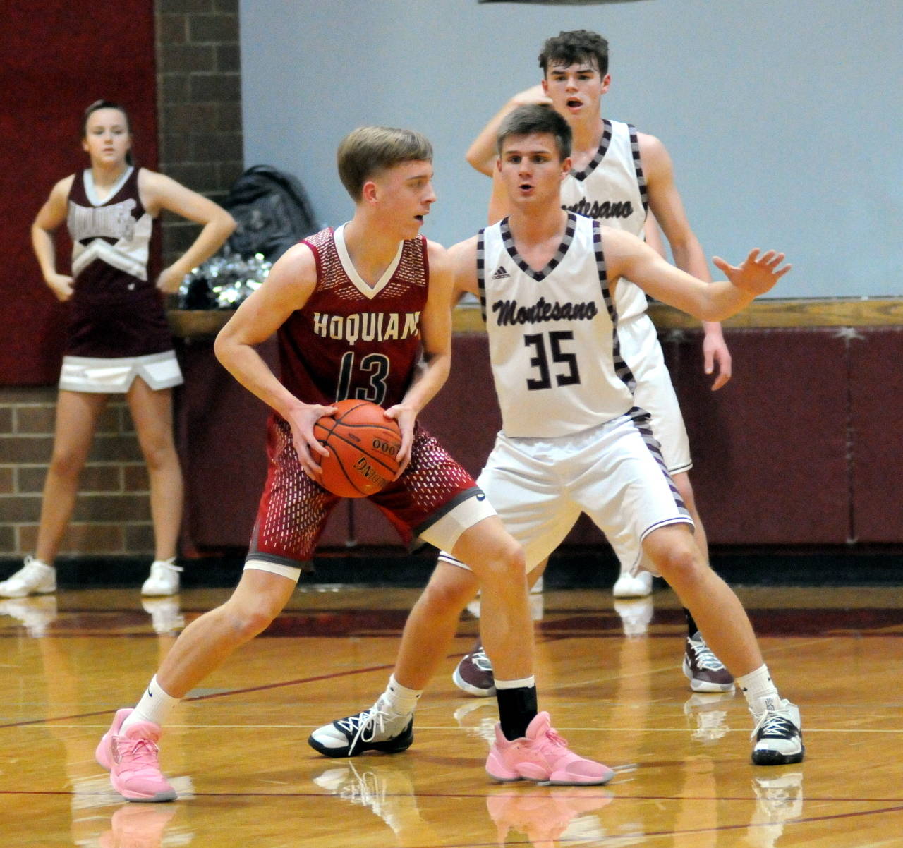 Hoquiam’s Zach Elsos looks for room to pass while being defended by Montesano’s Ben Wills during the Bulldogs’ 72-38 victory on Tuesday at Montesano High School. (Ryan Sparks | Grays Harbor News Group)