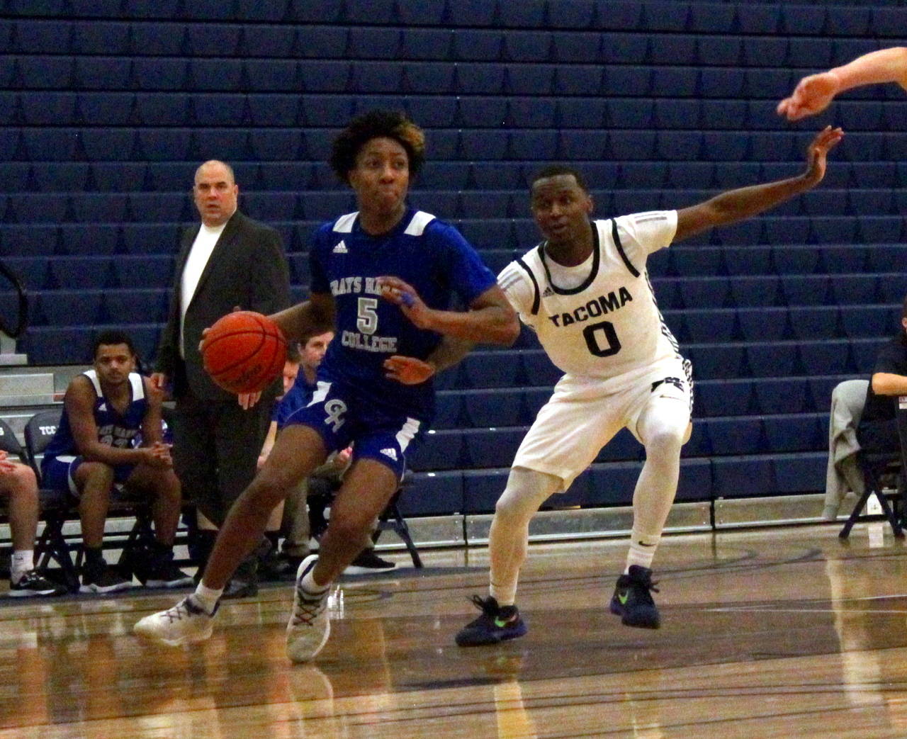 Grays Harbor guard Michael Sampson (5) dribbles looks for an opening against Tacoma point guard Emmett Linton III on Saturday in Tacoma. (Sumbitted photo)