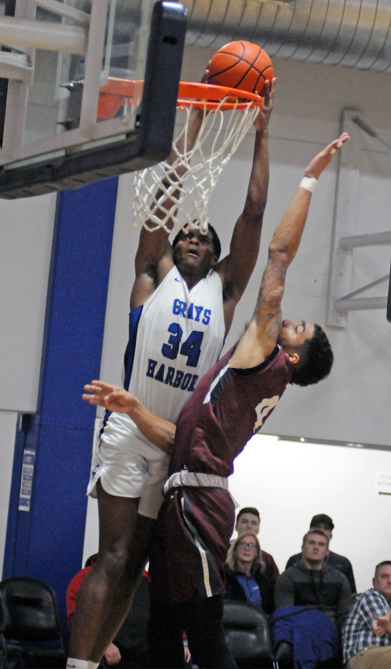Grays Harbor’s Antoine Hines (34) goes up for a dunk against Pierce College’s Spence McDonald during Wednesday’s NWAC West Region league-opener at Grays Harbor College. The Chokers won 93-68. (Ryan Sparks | Grays Harbor News Group)