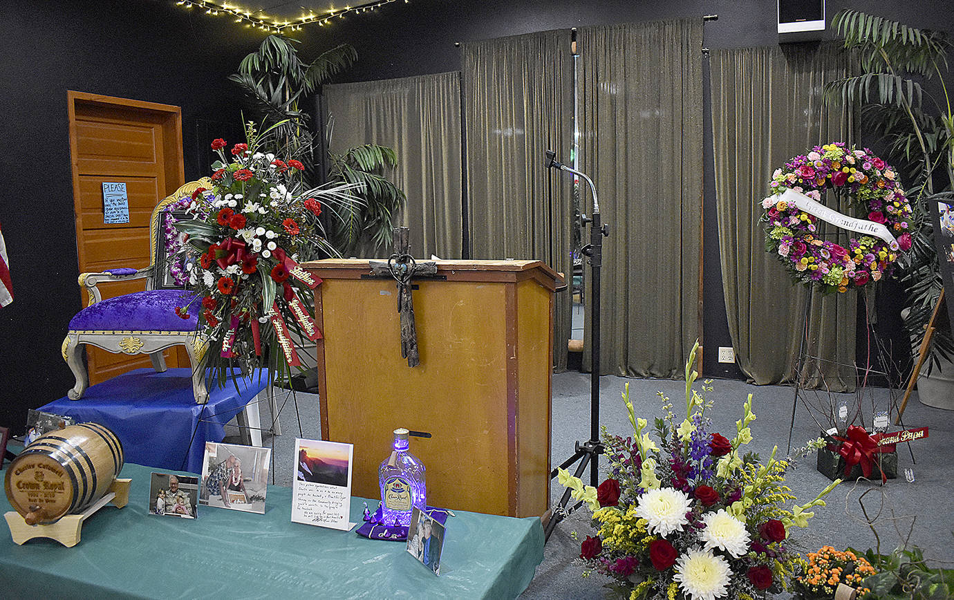 Above, photos, flowers and memories were displayed on the stage at the Montesano Moose Lodge on Friday as the venue hosted the celebration of life for Chuck Caldwell.                                Left, family, friends and colleagues gathered to share their memories of former Port of Grays Harbor Commissioner.