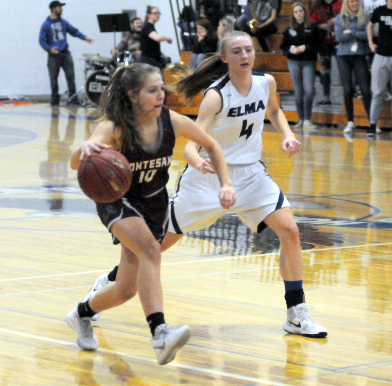 Montesano guard Jordan Karr, left, dribbles against Elma’s Jillian Bieker during Tuesday’s game in Elma. (Ryan Sparks | Grays Harbor News Group)