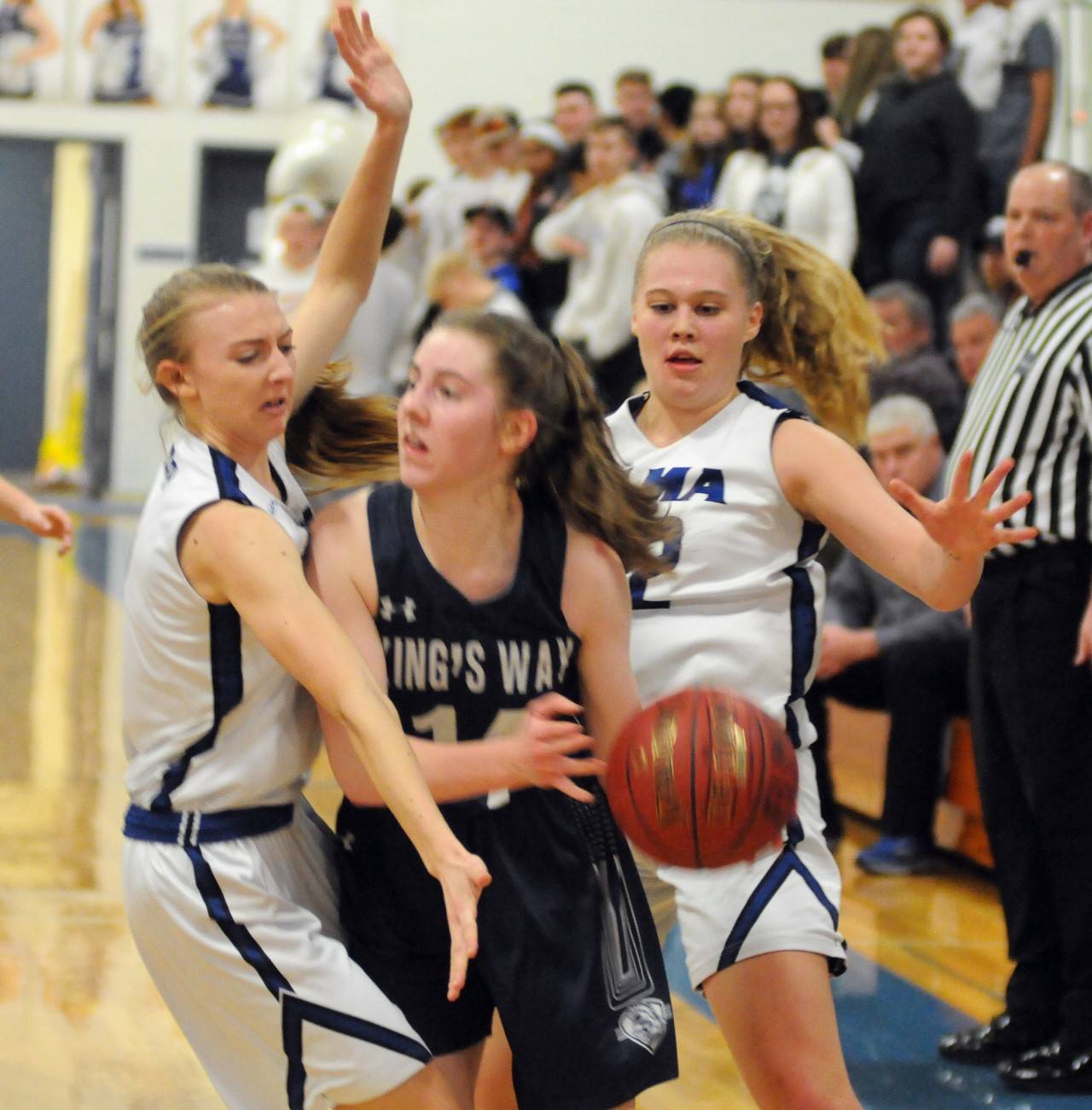 Elma’s Jillian Bieker, left, and Quin Mikel, right, pressure King’s Way Christian’s Laurel Quinn during Elma’s 45-26 1A District 4 Tournament victory on Saturday in Elma. The 26 points scored by KWC was a season-low for the Knights. (Ryan Sparks | Grays Harbor News Group)