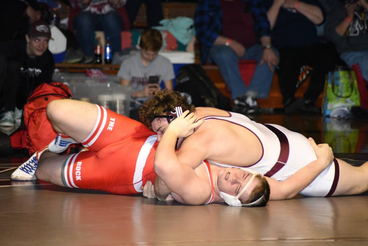 Montesano’s Kenny Koonrad works to secure the fall over Castle Rock’s Jonah McGary during Saturday’s regional meet at Hoquiam High School. Koonrad won the 285-pound title to help the Bulldogs to a team regional championship. (Photo by Sue Michalak Budsberg)