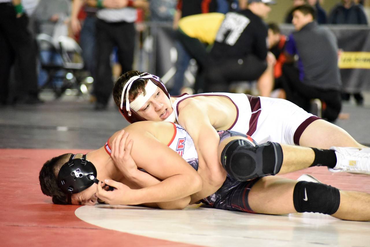 Montesano’s Ty Ekerson, top, controls Ricky Cisneros of Granger in the 145-pound 3rd/4th place match at the Mat Classic XXXII meet on Saturday in Tacoma. Ekerson won to place third in the state and help the Bulldogs to a third-place team finish. (Photo by Sue Michalak Budsberg)
