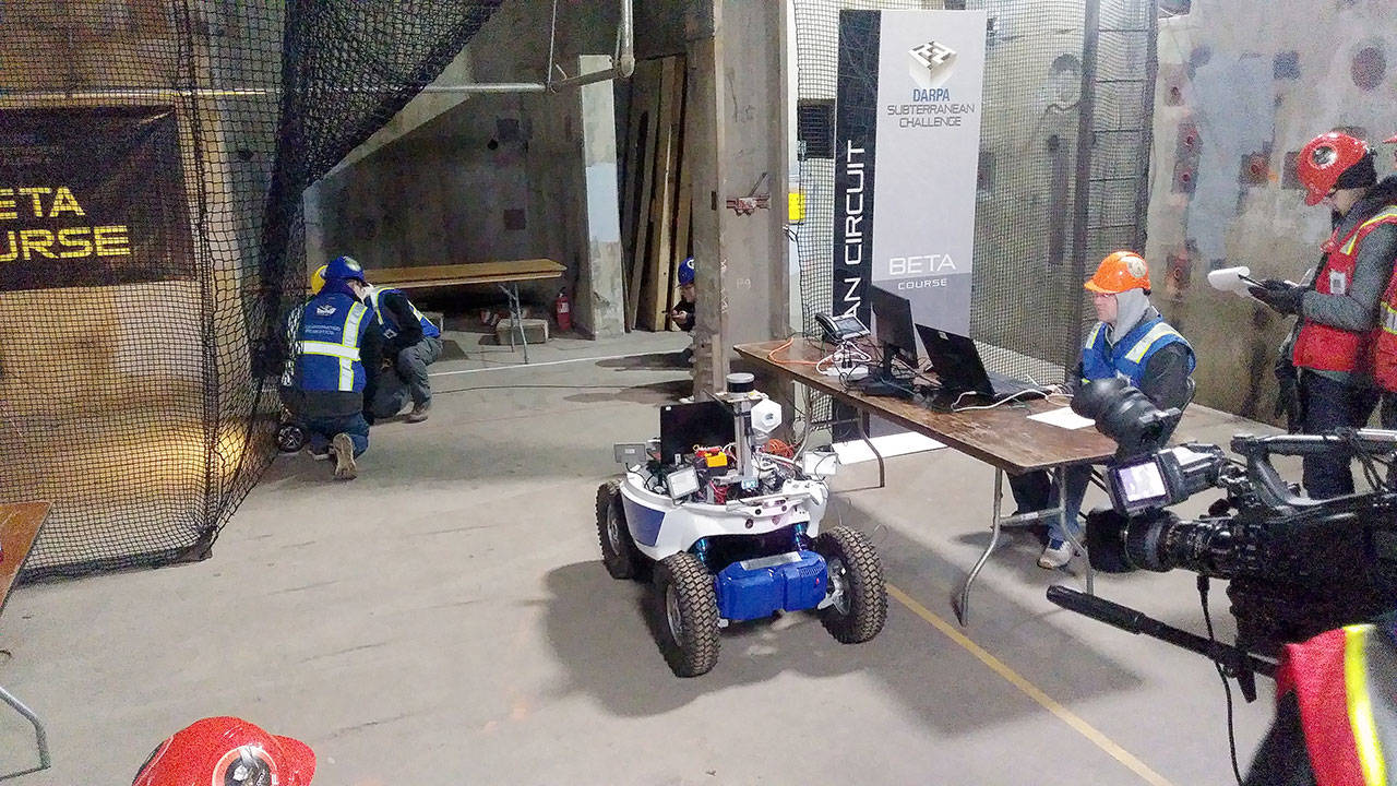 Kevin Knoedler, seated, manages the Coordinated Robotics team’s robots as they make their way into and through the Beta Course on Monday, Feb. 24, 2020, during the DARPA Subterranean Challenge at the Satsop Business Park in Elma. (Michael Lang | Grays Harbor News Group)