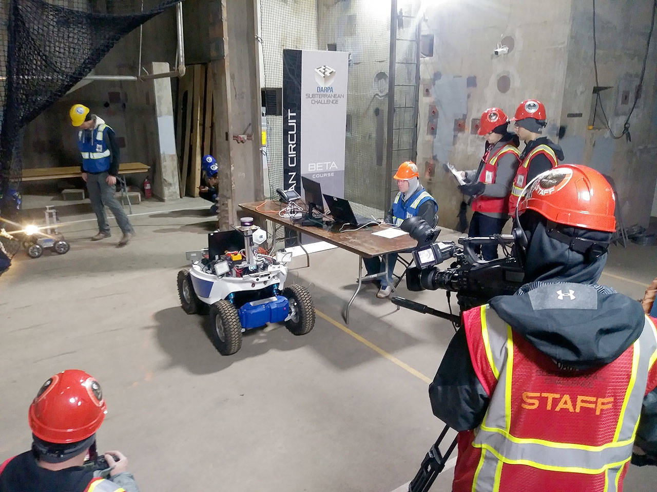 Michael Lang | Grays Harbor News Group                                Kevin Knoedler, seated, manages the Coordinated Robotics team’s robots as they make their way into and through the Beta Course on Monday during the DARPA Subterranean Challenge at the Satsop Business Park in Elma.