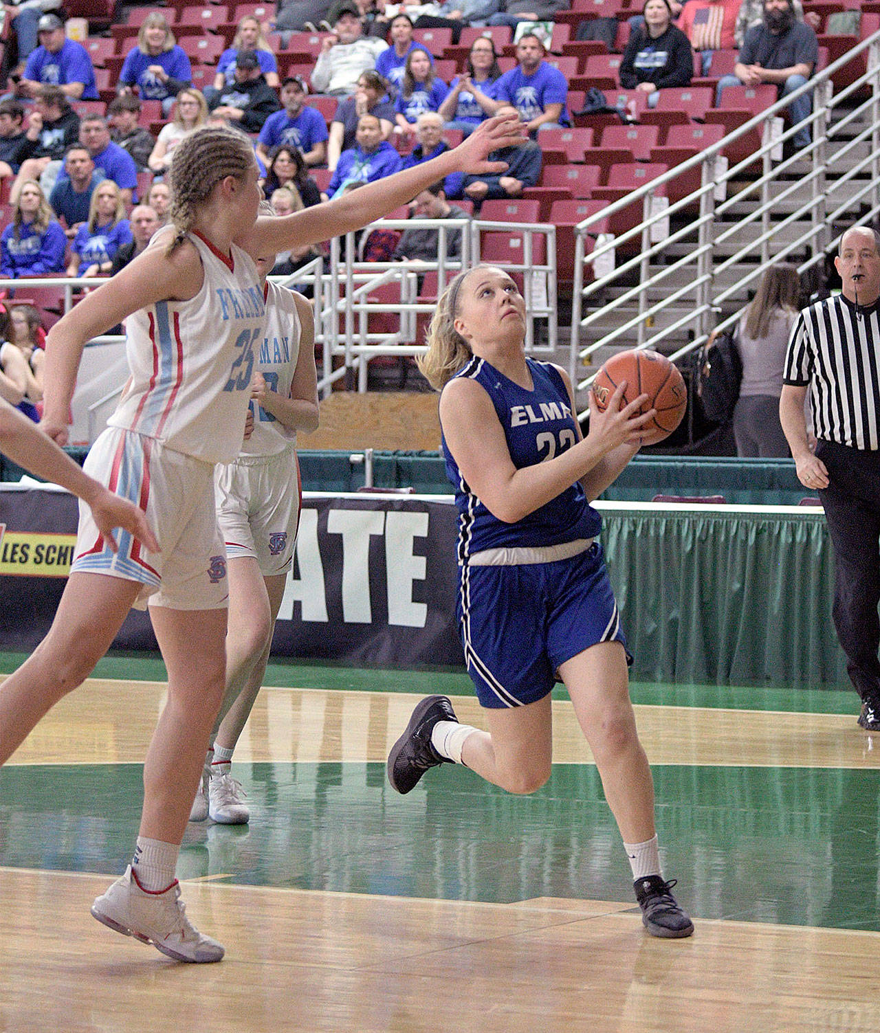 Elma’s Quin Mikel, right, drives the lane against Freeman’s Jordyn Goldsmith during the Eagles 49-25 loss in the first round of the 1A State Tournament on Wednesday at the SunDome in Yakima. (Photo by CJ Mudgett)