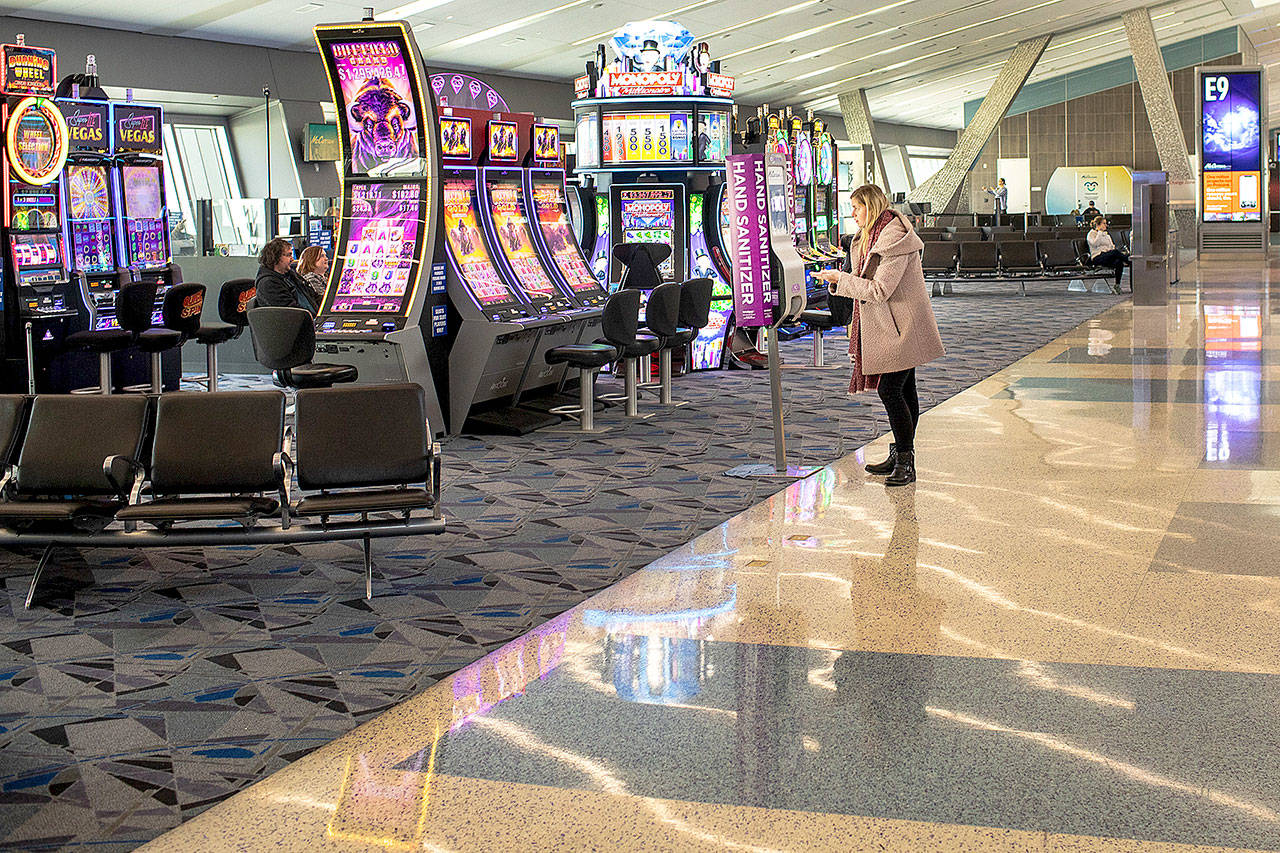 A woman uses a hand sanitizer station inside McCarran International Airport in Las Vegas. (Jay L. Clendenin/Los Angeles Times)