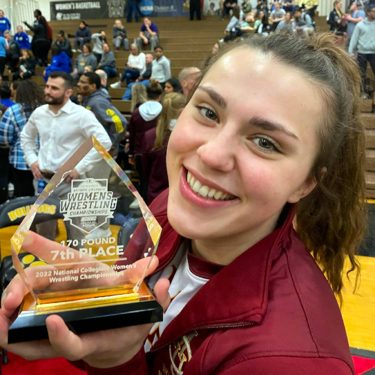 SUBMITTED PHOTO Former Aberdeen Bobcats and current Colorado Mesa University wrestler Tatum Heikkila poses with her seventh-place trophy at the NCWA Championships on Saturday in Adrian, Michigan. With her performance, Heikkila became the first Twin Harbors female wrestler to earn NCAA All-American status.