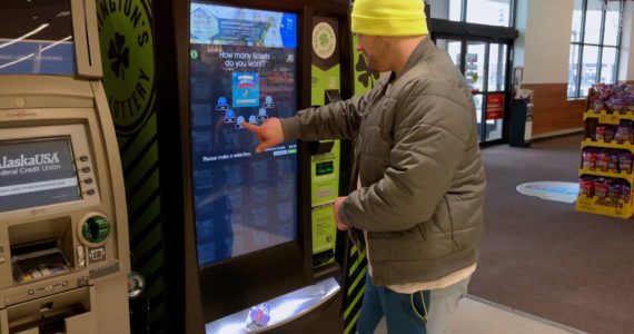 Aberdeen resident Landon Morse purchases a lottery ticket at the Safeway on Heron Street Monday, March 14. Erika Gebhardt I The Daily World