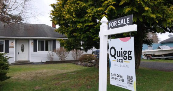 A Quigg & Co Real Estate sign dots the front lawn of home at 1911 Coolidge Road in Aberdeen. Erika Gebhardt | The Daily World