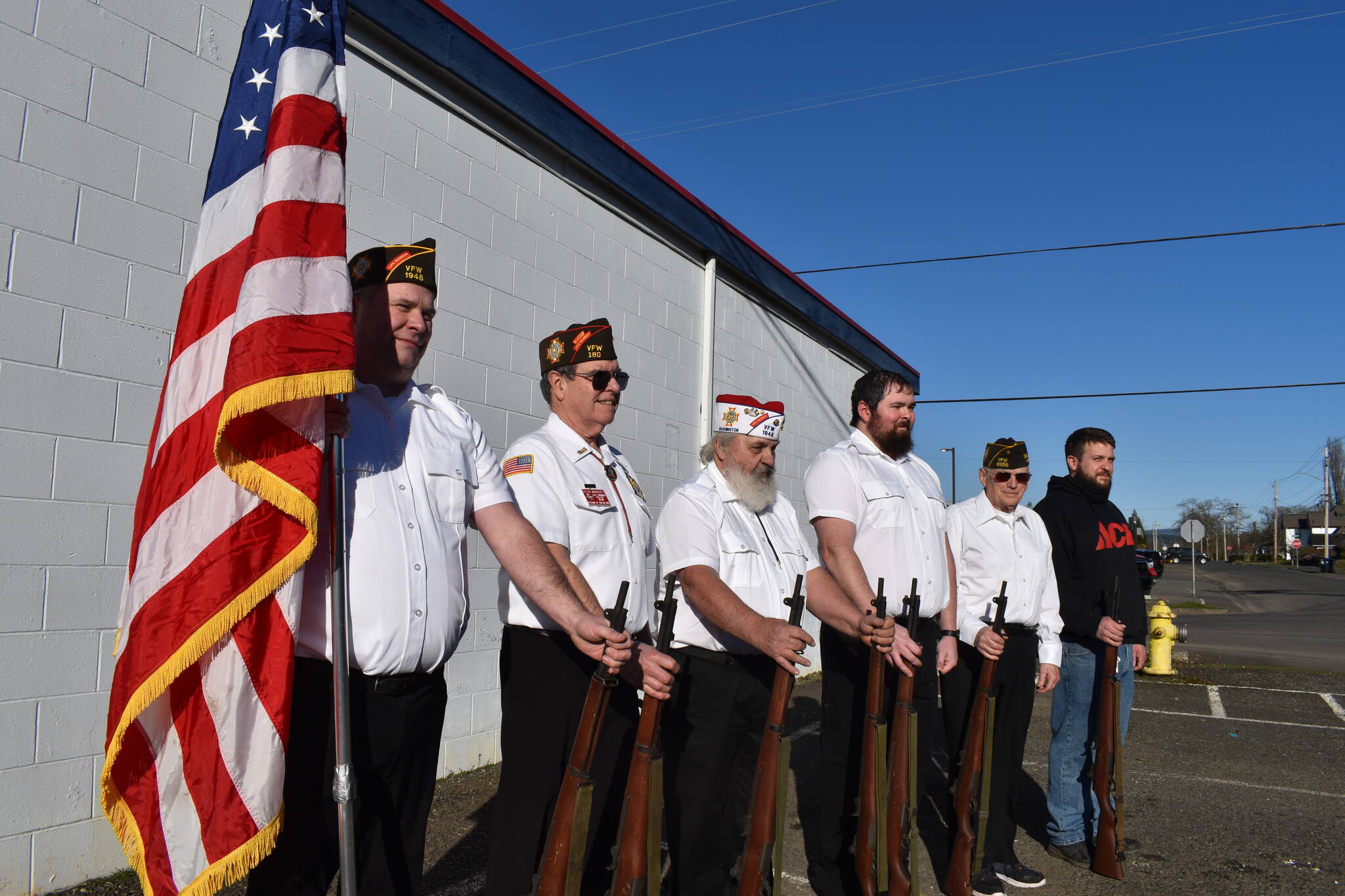 Elma VFW Bill Mann Post 1948 members (from left to right) Jim Mears, Tyler Marriott, Bill Wickwire, Cody Fries, Chuck McLane and Brad Dendy line up with an American flag and the seven ceremonial M1 Garand rifles that, once stolen, have since been recovered. The members couldn’t be more relieved. Matthew N. Wells | The Daily World