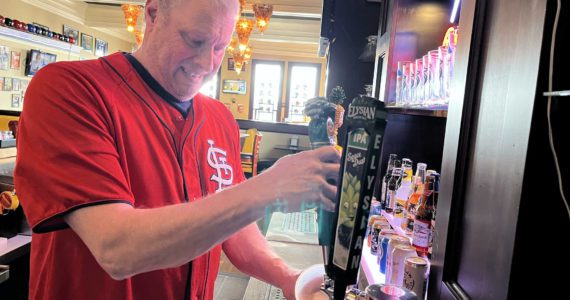 Tom Sutera, owner of Game Day Sports Bar and Grill — 212 S. I St., — pours a Kona Brewing Big Wave Golden Ale at the start of business late Thursday morning, March 31. Matthew N. Wells | The Daily World