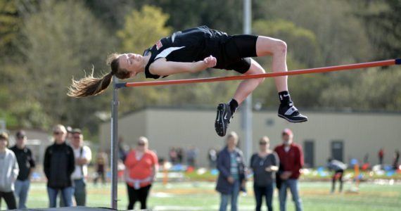 RYAN SPARKS | THE DAILY WORLD Raymond senior Kyra Gardner clears the bar in the high jump event at the Henrie-Weisel Tri-District Meet on Thursday at South Bend High School. Gardner cleared five feet, eight inches to win the event, tying her season-best and the state’s second-best mark in the process.