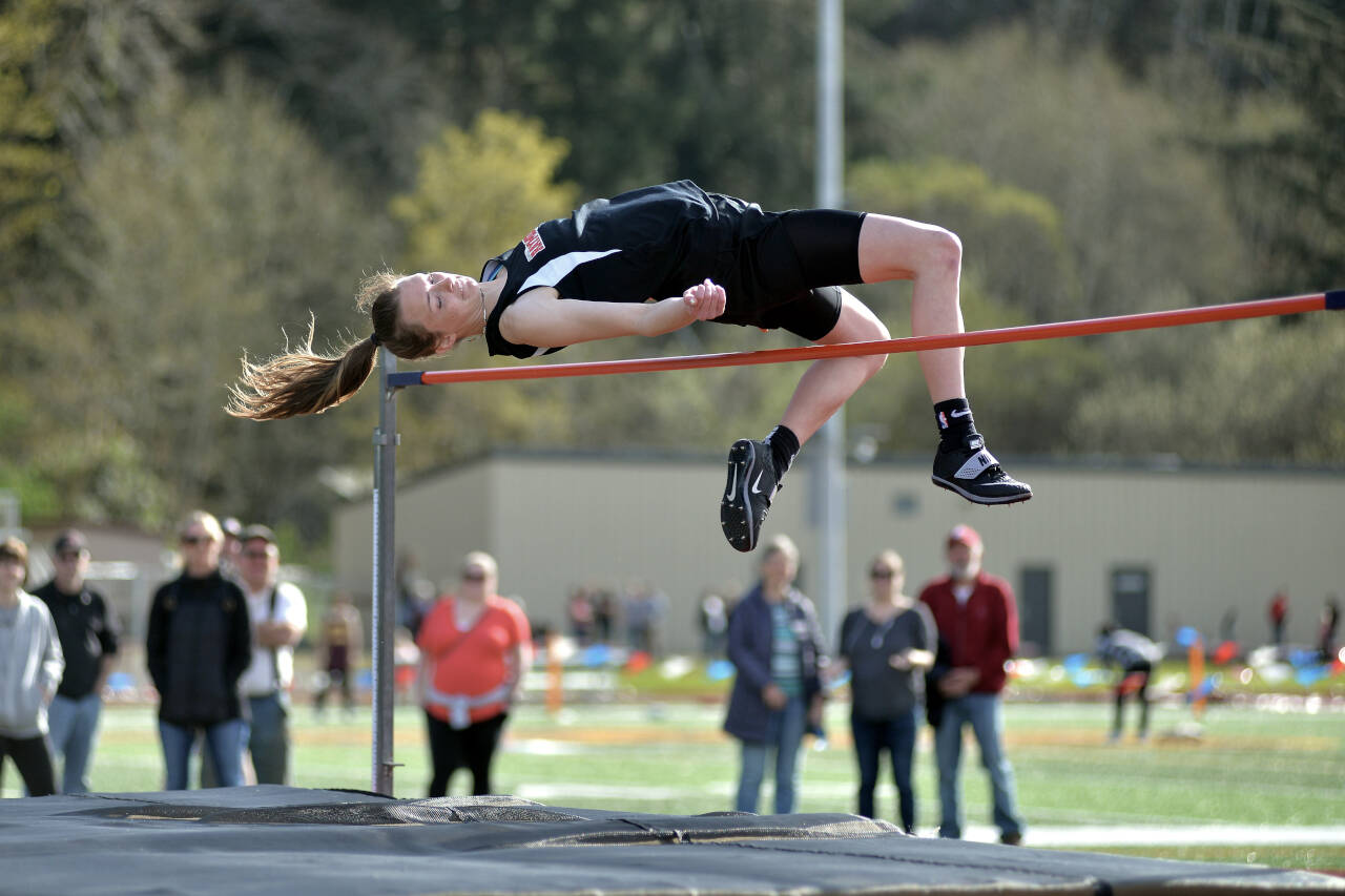 RYAN SPARKS | THE DAILY WORLD Raymond senior Kyra Gardner clears the bar in the high jump event at the Henrie-Weisel Tri-District Meet on Thursday at South Bend High School. Gardner cleared five feet, eight inches to win the event, tying her season-best and the state’s second-best mark in the process.