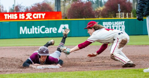 PHOTO BY SHAWN DONNELLY Montesano’s Jackson Busz dives back into first base during the Bulldogs’ 9-5 loss to Jefferson on Saturday at Cheney Stadium in Tacoma.