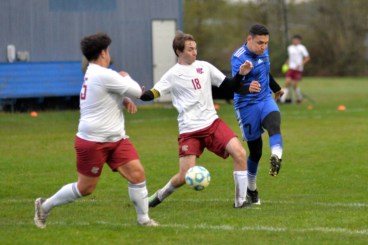 RYAN SPARKS | THE DAILY WORLD Elma midfielder Valencia Mendoza, right, scores on a shot while being defended by Hoquiam senior Kolby Skolrood during Elma’s 9-0 win on Wednesday at Davis Field in Elma. Mendoza scored five goals and had two assists in the game.