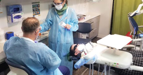 A patient is getting a chipped tooth repaired by the dentists inside the SmileMobile on April 26, 2022, in Elma. Allen Leister l The Daily World