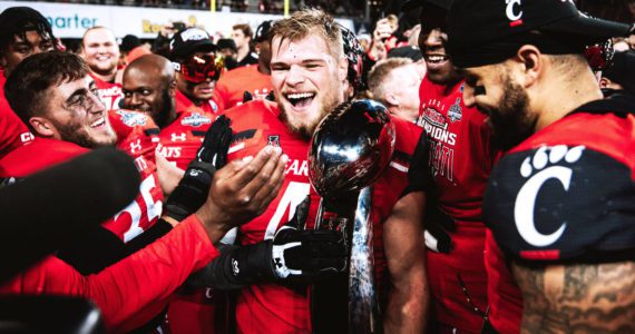 Joel Dublanko (center) celebrates with teammates following the Bearcats AAC Championship game victory over the Houston Cougars at Nippert Stadium in Cincinnati, Ohio on Dec. 4, 2021. (Photo courtesy of Joel Dublanko)