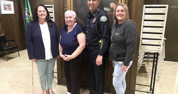 (Matthew N. Wells | The Daily World) Aberdeen Police Department Chief Steve Shumate stands from left, with his wife Mandy, his mother Charlotte, and his sister Cindy Stutesman. Shumate, retiring June 30, 2022, after 33 years of service combined in Grays Harbor County, is “ready for a break.” His family is excited to have him back home. Mandy can’t wait for him to fulfill his promise to her, which is to cook for her every night.