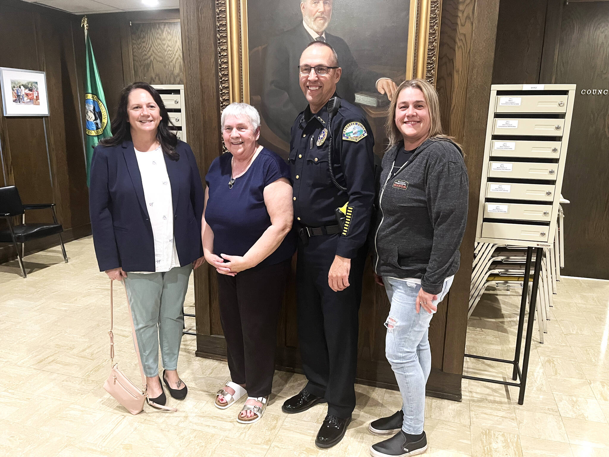 (Matthew N. Wells | The Daily World) Aberdeen Police Department Chief Steve Shumate stands from left, with his wife Mandy, his mother Charlotte, and his sister Cindy Stutesman. Shumate, retiring June 30, 2022, after 33 years of service combined in Grays Harbor County, is “ready for a break.” His family is excited to have him back home. Mandy can’t wait for him to fulfill his promise to her, which is to cook for her every night.