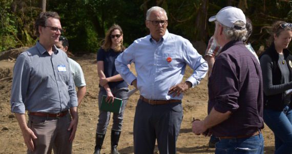 (Allen Leister | The Daily World)
                                Gov. Inslee (center) stands around board members from the Office of Chehalis Basis as they describe the work being done for the Wynoochee River restoration as part of the Early Action Reach projects. The Wynoochee River restoration project, which started in 2021, is slated for completion by the end of the summer.