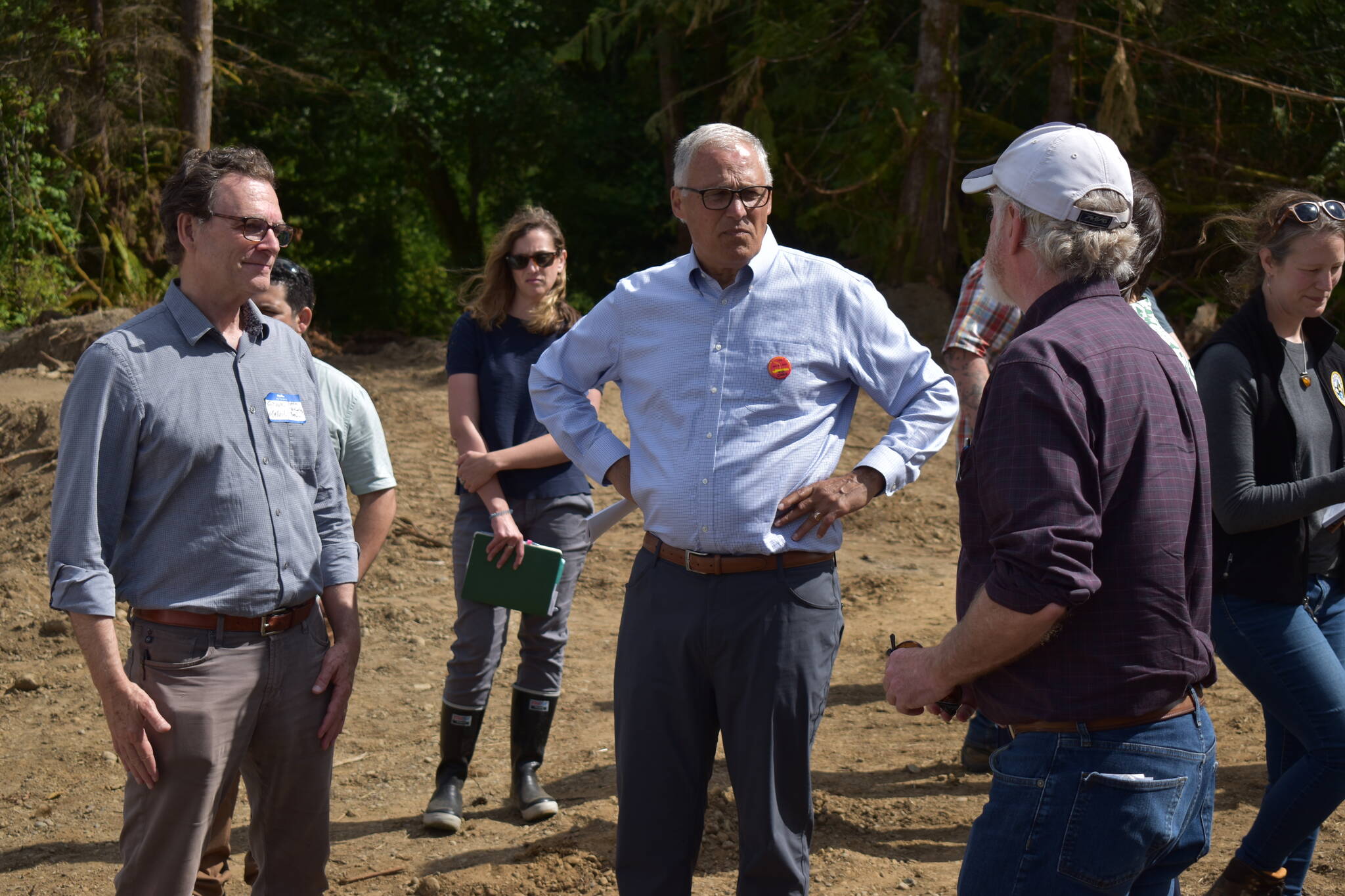 (Allen Leister | The Daily World)
                                Gov. Inslee (center) stands around board members from the Office of Chehalis Basis as they describe the work being done for the Wynoochee River restoration as part of the Early Action Reach projects. The Wynoochee River restoration project, which started in 2021, is slated for completion by the end of the summer.