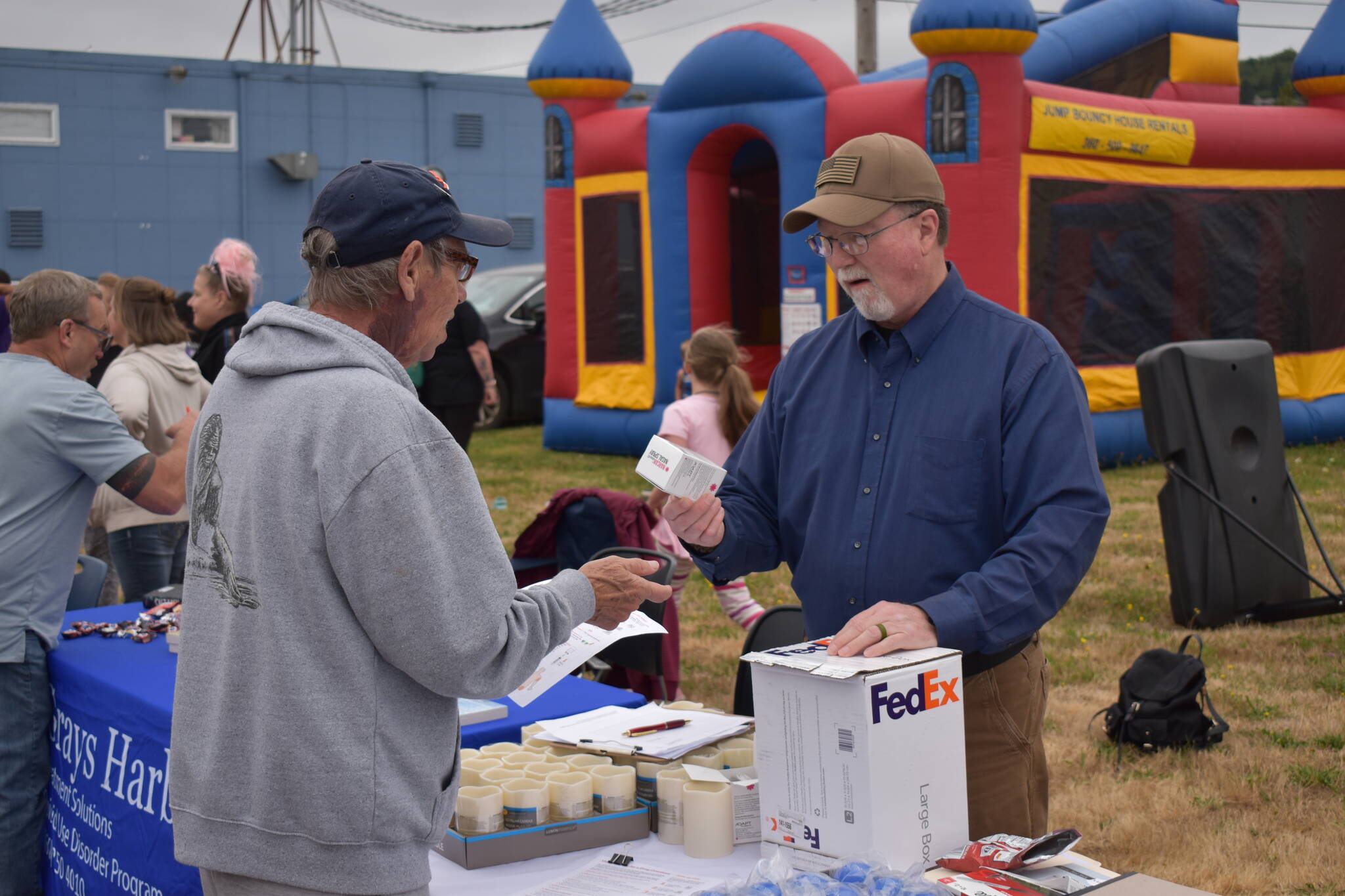 (Allen Leister | The Daily World)
                                Professional health officials such as Kenneth Bangs (Right), provided the public with education and distribution of resources like NARCAN and Fentanyl test strips that can used to help overdosed individuals on Aug. 31, at the Overdose Awareness Day event, in Aberdeen.