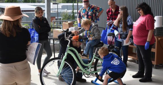 (Allen Leister | The Daily World)
                                Families patiently waited in line for their chance to use the smoothie-making bicycle at the Summit Pacific Peak Health Fair, on Saturday, Sept. 17, in Elma. The custom-made bicycle, which will be present at every future Summit Pacific event, was obtained via a $1,000 grant.