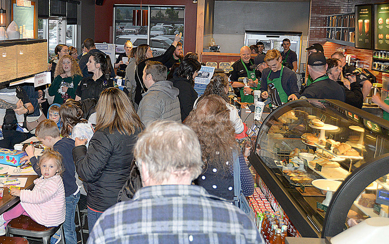 (Dan Hammock / The Daily World file)
                                Police and Aberdeen residents crowd the Aberdeen Starbucks in 2022 for Badges & Brews. This year’s event brought the Aberdeen Fire Department, Grays Harbor County Sheriff’s Office and Aberdeen emergency management personnel to the event.