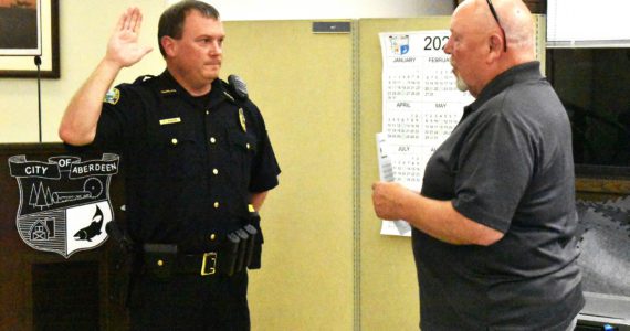 Aberdeen Police Department Chief Dale Green swears in with Aberdeen Mayor Pete Schave on Wednesday night, Sept. 28, at the Aberdeen City Council meeting in the council chambers. Green, who was interim chief since now-retired Chief Steve Shumate retired June 30, will start as chief of police on Saturday, Oct. 1. (Matthew N. Wells | The Daily World)