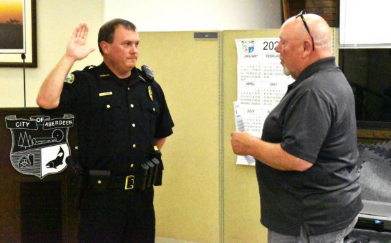 Aberdeen Police Department Chief Dale Green swears in with Aberdeen Mayor Pete Schave on Wednesday night, Sept. 28, at the Aberdeen City Council meeting in the council chambers. Green, who was interim chief since now-retired Chief Steve Shumate retired June 30, will start as chief of police on Saturday, Oct. 1. (Matthew N. Wells | The Daily World)