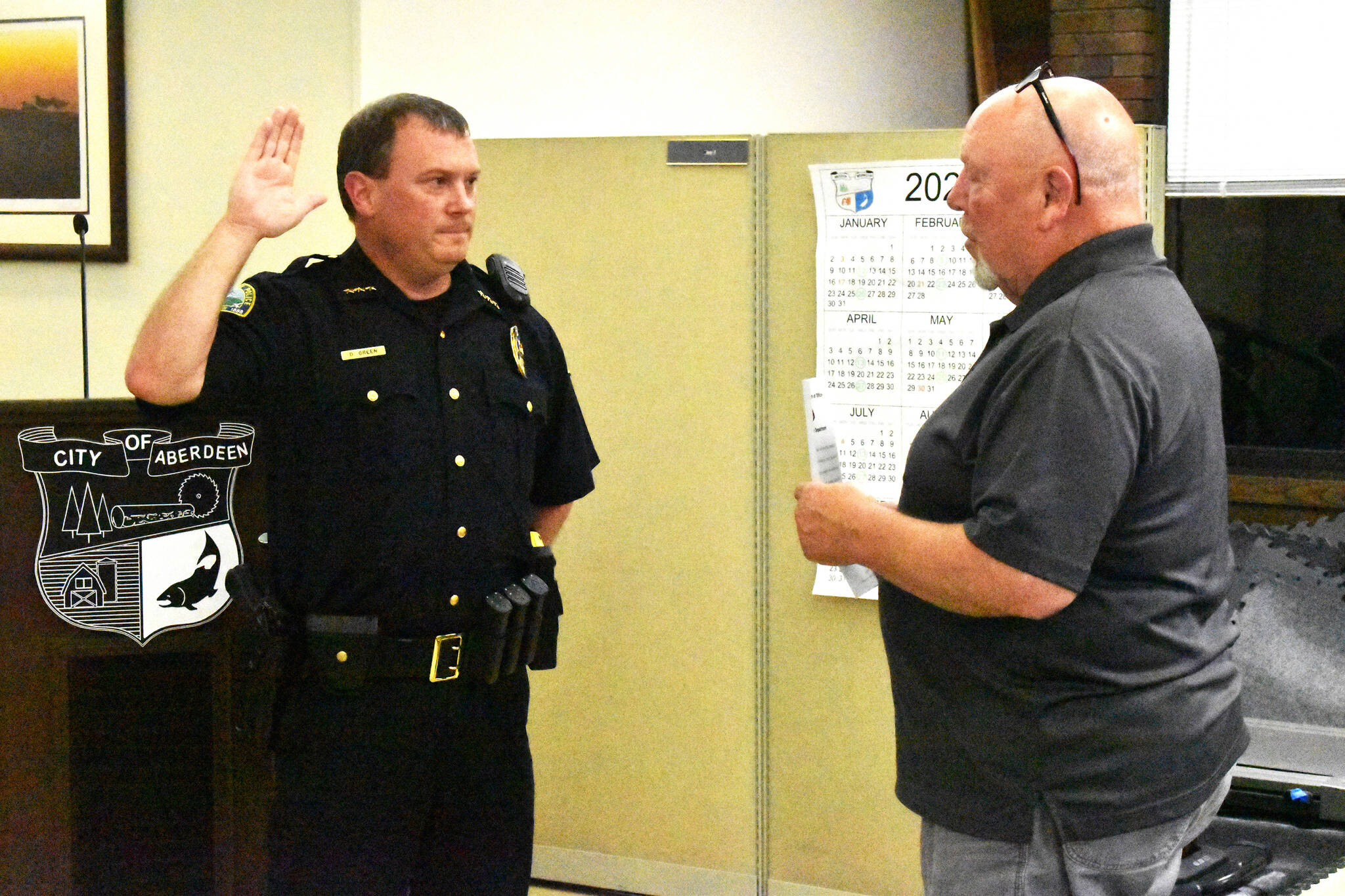 Aberdeen Police Department Chief Dale Green swears in with Aberdeen Mayor Pete Schave on Wednesday night, Sept. 28, at the Aberdeen City Council meeting in the council chambers. Green, who was interim chief since now-retired Chief Steve Shumate retired June 30, will start as chief of police on Saturday, Oct. 1. (Matthew N. Wells | The Daily World)